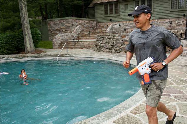President Obama having a water gun fight with daughter Sasha last year at Camp David